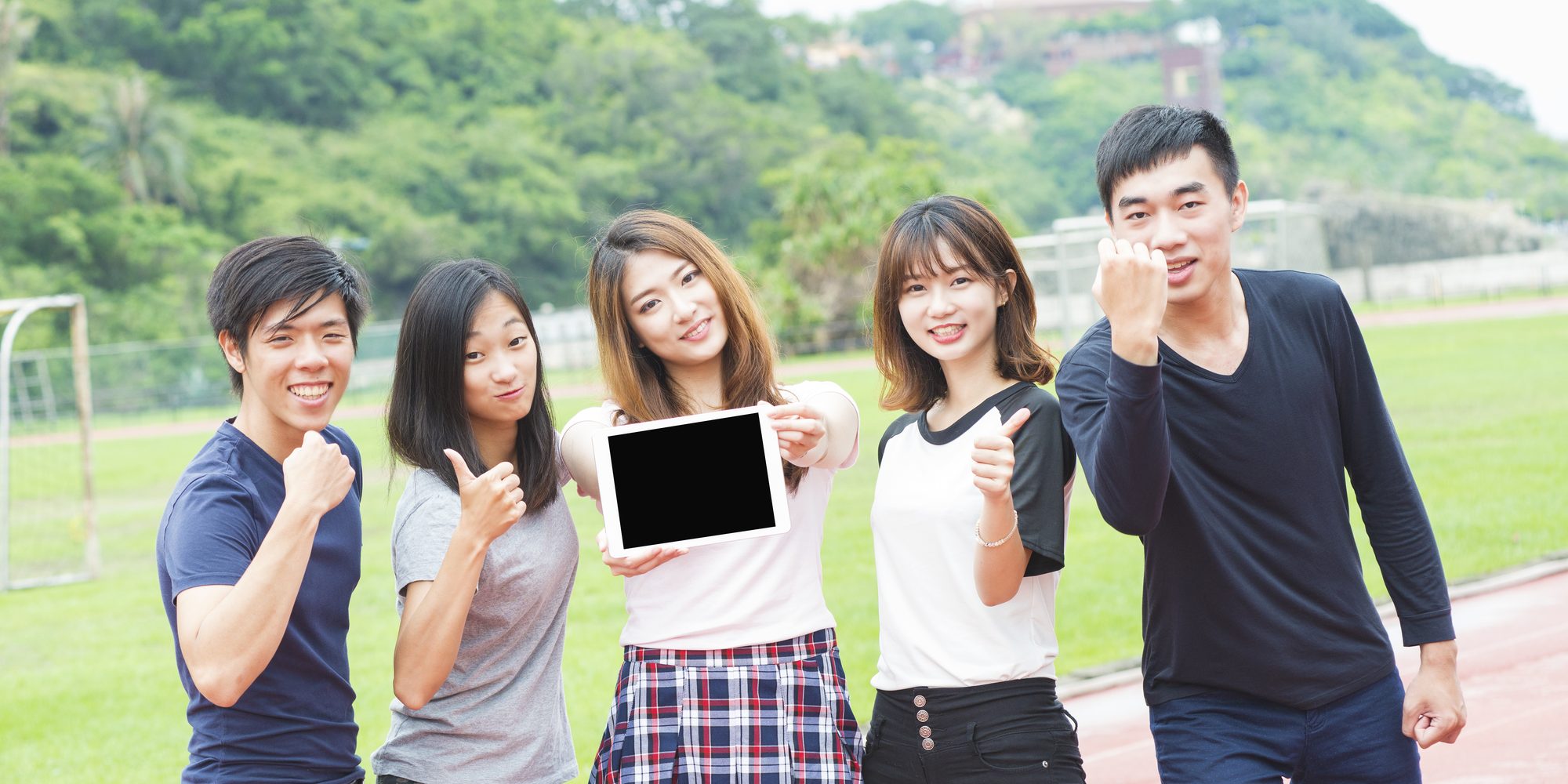 group of happy teen high school students outdoors
